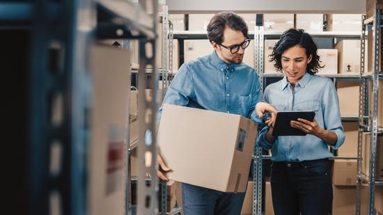 couple with a box in warehouse